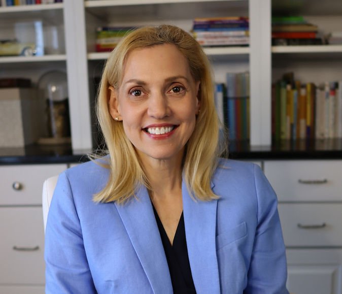 Tammy Vetter smiling in a blue blazer in her office